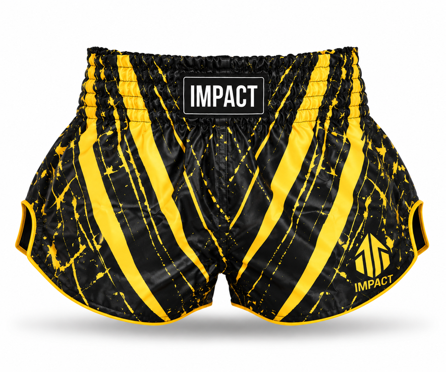 Black and gold IMPACT Muay Thai shorts with high curved side hems and IMPACT waistband branding
