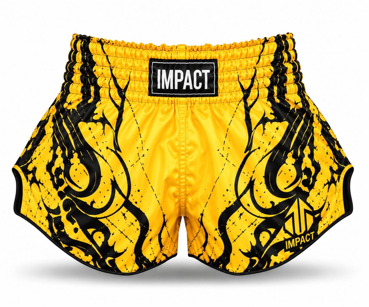 Yellow and black IMPACT Muay Thai shorts with black graphic flourishes and curved high-cut hems